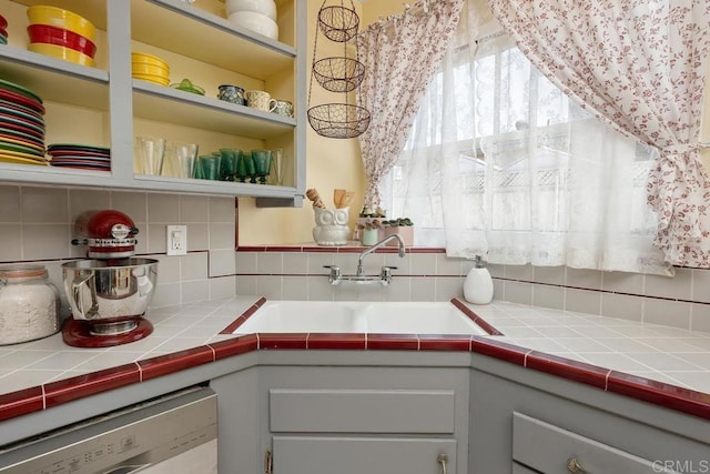 4886 Twain Ave, San Diego, CA 92120 - kitchen featuring decorative backsplash, dishwashing machine, open shelves, and tile countertops