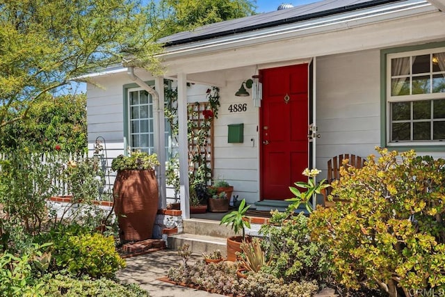 4886 Twain Ave, San Diego, CA 92120 - property entrance with a porch and roof mounted solar panels