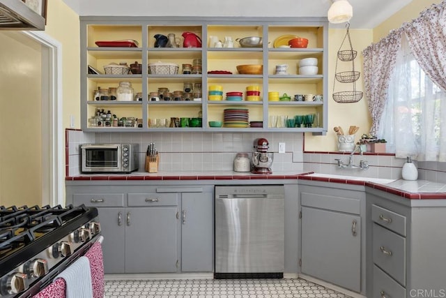 4886 Twain Ave, San Diego, CA 92120 - kitchen featuring stainless steel appliances, gray cabinetry, decorative backsplash, open shelves, and light countertops