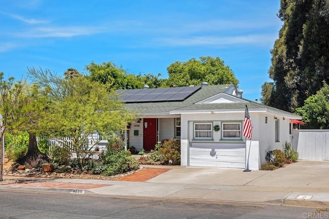 4886 Twain Ave, San Diego, CA 92120 - view of front of house featuring solar panels, a shingled roof, and driveway