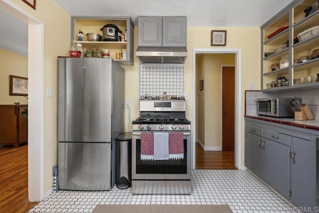 4886 Twain Ave, San Diego, CA 92120 - kitchen featuring appliances with stainless steel finishes, open shelves, gray cabinets, and tile counters