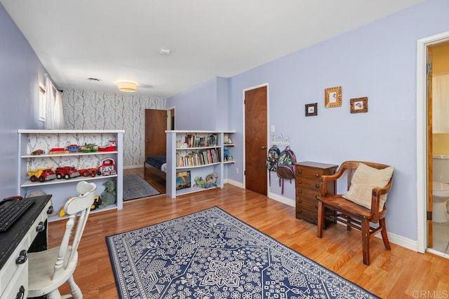 4886 Twain Ave, San Diego, CA 92120 - sitting room with wood finished floors, wallpapered walls, and an accent wall