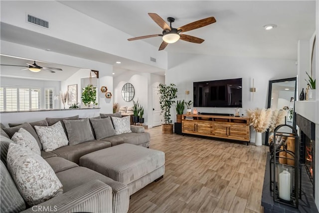 32175 Cedarcroft Rd, Acton, CA 93510 - living room featuring ceiling fan, lofted ceiling, a warm lit fireplace, light wood-style floors, and recessed lighting