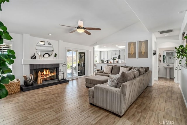 32175 Cedarcroft Rd, Acton, CA 93510 - living area featuring ceiling fan, light wood finished floors, a glass covered fireplace, and lofted ceiling