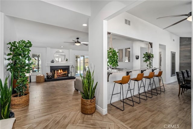 32175 Cedarcroft Rd, Acton, CA 93510 - kitchen with ceiling fan, a kitchen breakfast bar, a lit fireplace, open floor plan, and recessed lighting