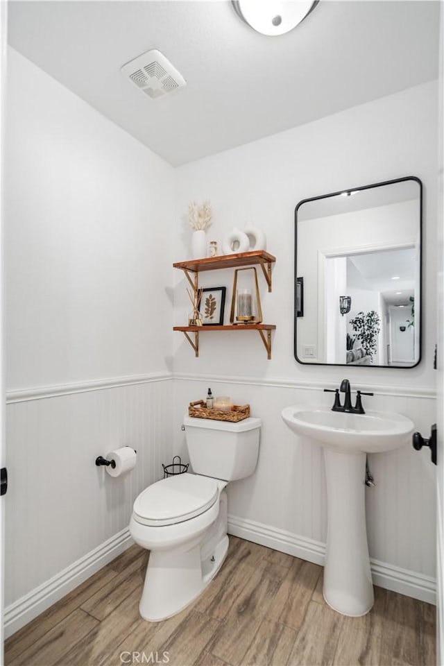 32175 Cedarcroft Rd, Acton, CA 93510 - half bathroom with wood finished floors and a wainscoted wall