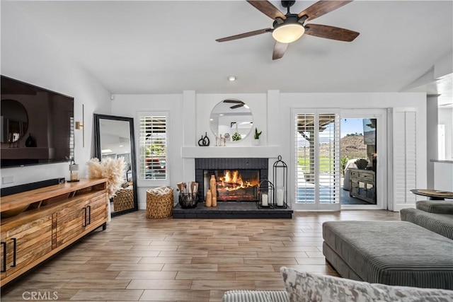 32175 Cedarcroft Rd, Acton, CA 93510 - living room with plenty of natural light, a fireplace, a ceiling fan, wood finished floors, and vaulted ceiling