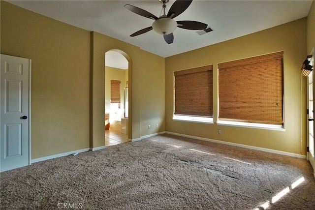 845 E Redwood Cir, Hanford, CA 93230 - unfurnished bedroom with arched walkways, carpet flooring, a ceiling fan, and ensuite bath