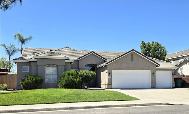 845 E Redwood Cir, Hanford, CA 93230 - ranch-style home featuring a garage, concrete driveway, stucco siding, and a tiled roof