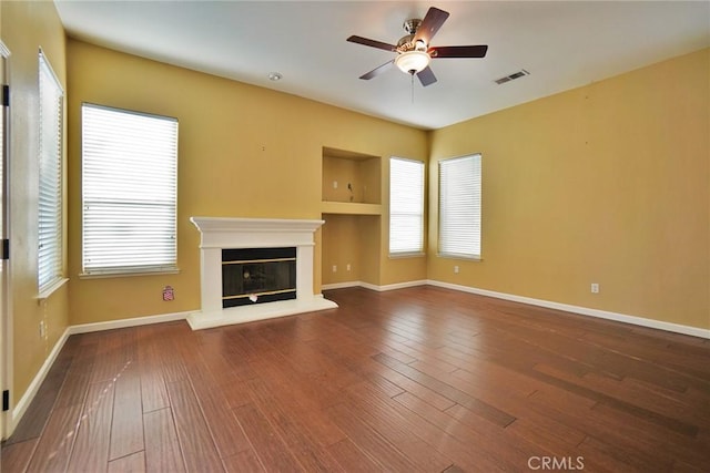 845 E Redwood Cir, Hanford, CA 93230 - unfurnished living room featuring a ceiling fan, a glass covered fireplace, and wood-type flooring