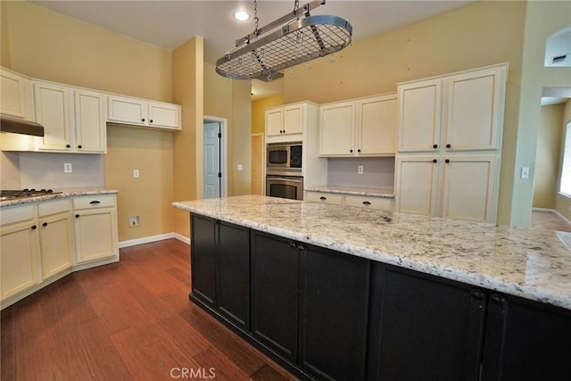 845 E Redwood Cir, Hanford, CA 93230 - kitchen featuring dark wood-type flooring, under cabinet range hood, appliances with stainless steel finishes, and light stone counters