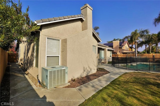 845 E Redwood Cir, Hanford, CA 93230 - view of side of property with a fenced backyard, stucco siding, a patio, and a chimney