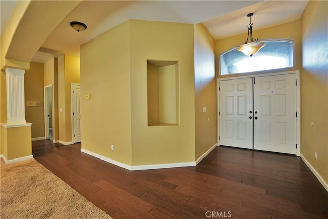 845 E Redwood Cir, Hanford, CA 93230 - foyer entrance with decorative columns, arched walkways, and dark wood-style flooring