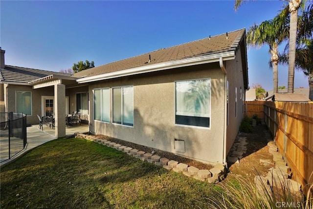 845 E Redwood Cir, Hanford, CA 93230 - back of house featuring a fenced backyard, stucco siding, and a patio area