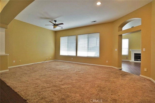 845 E Redwood Cir, Hanford, CA 93230 - empty room featuring a ceiling fan, carpet floors, a fireplace, recessed lighting, and wood finished floors