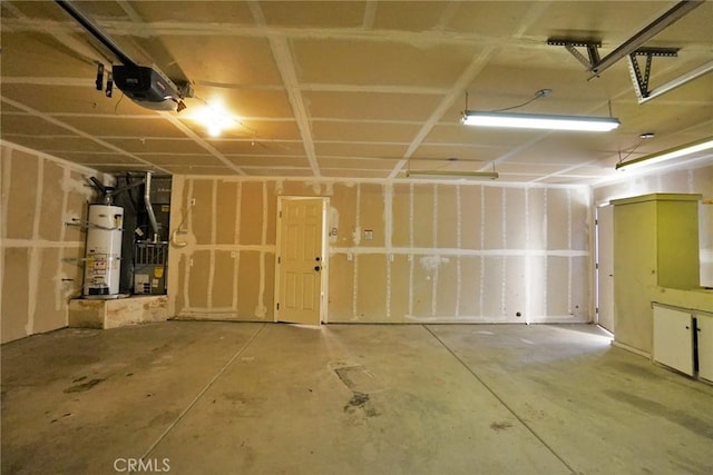 845 E Redwood Cir, Hanford, CA 93230 - garage with strapped water heater, a garage door opener, and heating unit