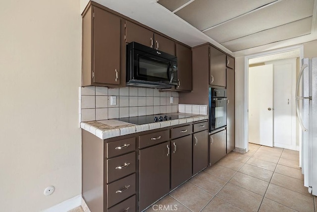 5870 Green Valley Cir Unit 231, Culver City, CA 90230 - kitchen with black appliances, tile counters, decorative backsplash, and dark brown cabinets
