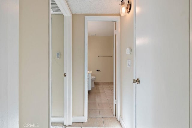 5870 Green Valley Cir Unit 231, Culver City, CA 90230 - hallway with light tile patterned flooring and baseboards