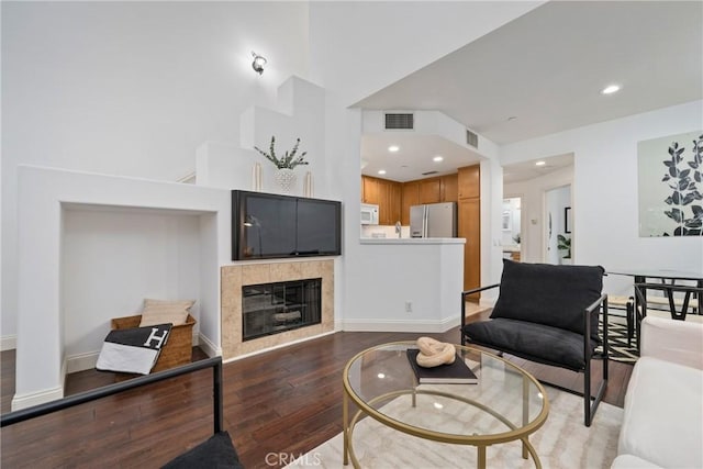 322 Dewdrop, Irvine, CA 92603 - living room with wood finished floors, a tiled fireplace, and recessed lighting