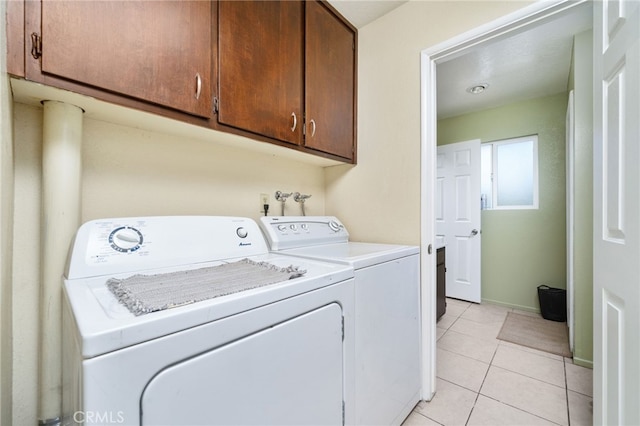 10147 Primrose Ave, Hesperia, CA 92345 - laundry room featuring cabinet space, washer and clothes dryer, and light tile patterned floors