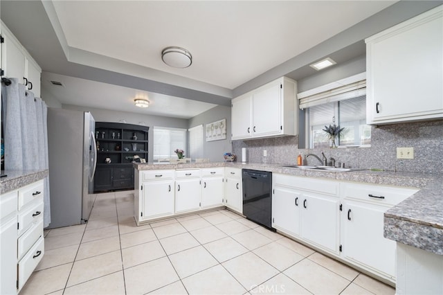 10147 Primrose Ave, Hesperia, CA 92345 - kitchen with black dishwasher, freestanding refrigerator, a peninsula, tasteful backsplash, and light tile patterned floors