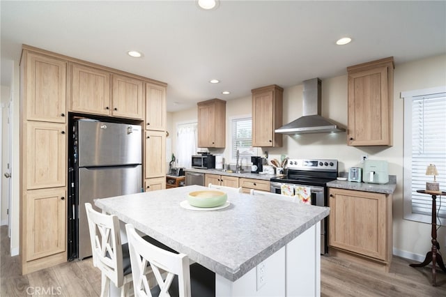 10147 Primrose Ave, Hesperia, CA 92345 - kitchen with wall chimney range hood, stainless steel appliances, light brown cabinets, and recessed lighting