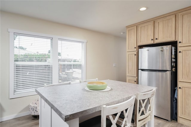 10147 Primrose Ave, Hesperia, CA 92345 - kitchen with freestanding refrigerator, light brown cabinets, light wood-style floors, recessed lighting, and a kitchen island