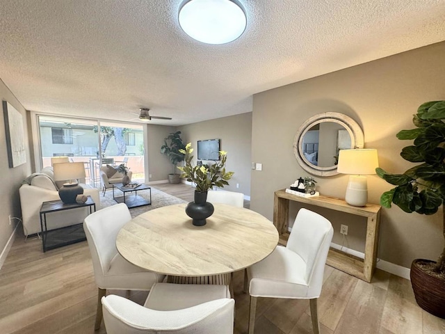 6182 Agee St Unit 193, San Diego, CA 92122 - dining room featuring a textured ceiling, light wood-style flooring, and a ceiling fan