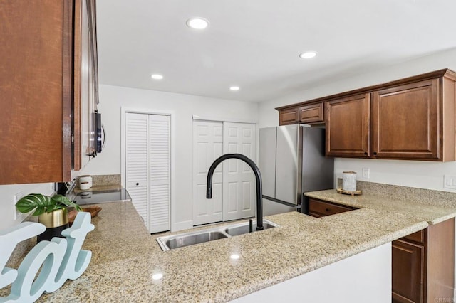 6876 Bear River Row Unit 3, San Diego, CA 92139 - kitchen with appliances with stainless steel finishes, light stone countertops, recessed lighting, and a peninsula