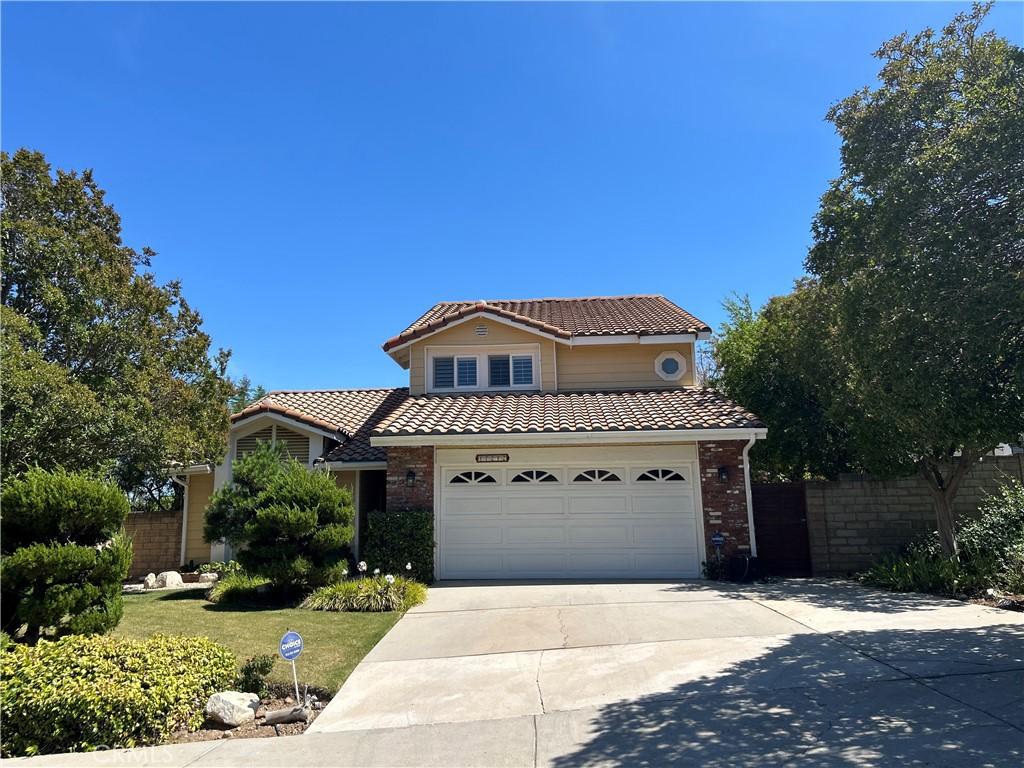 17252 Wentzel Way, Granada Hills, CA 91344 - view of front facade with a tiled roof, driveway, a garage, and brick siding