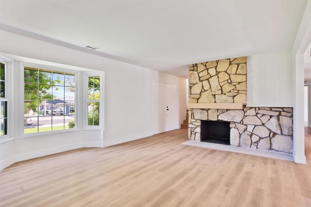 286 E Mission Rd, Corona, CA 92879 - unfurnished living room featuring light wood-style floors and a stone fireplace