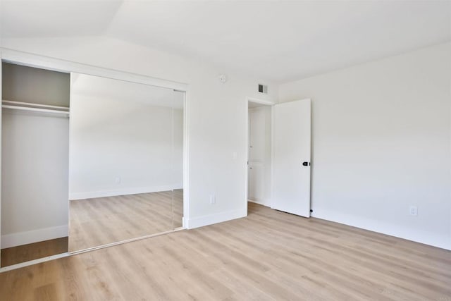 286 E Mission Rd, Corona, CA 92879 - unfurnished bedroom with wood finished floors, a closet, and lofted ceiling