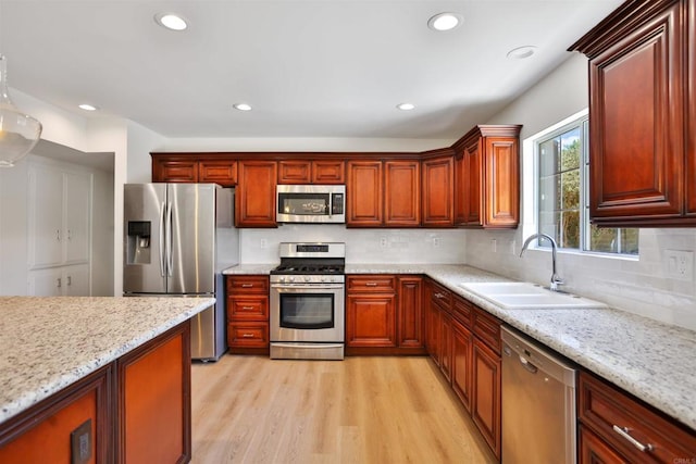 286 E Mission Rd, Corona, CA 92879 - kitchen with appliances with stainless steel finishes, light wood-style flooring, decorative backsplash, recessed lighting, and light stone counters