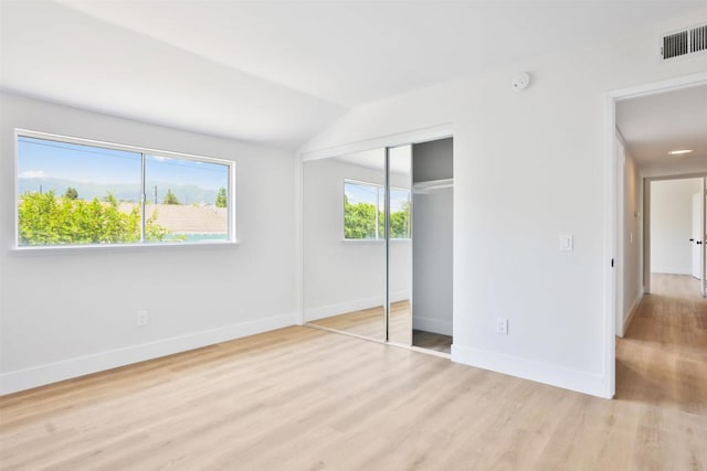286 E Mission Rd, Corona, CA 92879 - unfurnished bedroom featuring light wood-style flooring, lofted ceiling, and a closet