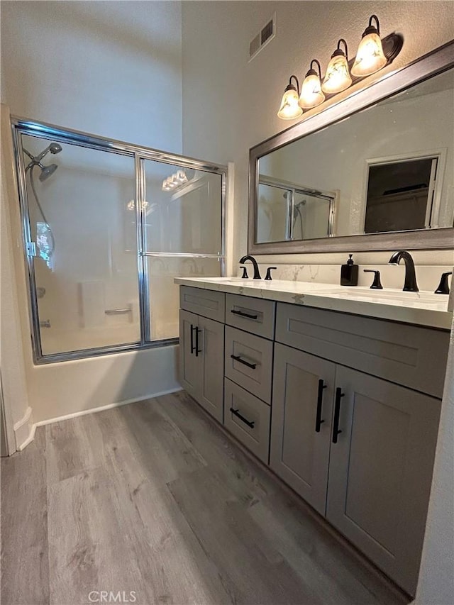 132 Sandpiper Ln, Aliso Viejo, CA 92656 - bathroom featuring wood finished floors, shower / bath combination with glass door, and double vanity