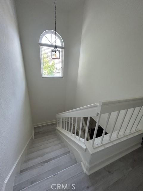 132 Sandpiper Ln, Aliso Viejo, CA 92656 - staircase featuring wood finished floors and a chandelier