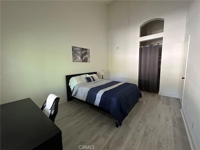 132 Sandpiper Ln, Aliso Viejo, CA 92656 - bedroom featuring light wood-type flooring, a towering ceiling, and a desk