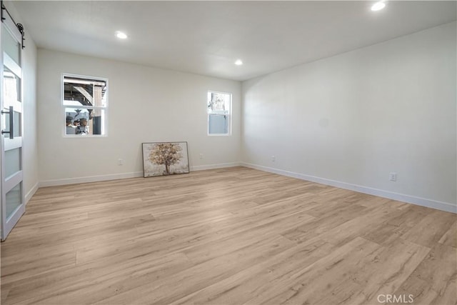 8283 Cornwall Ave, Rancho Cucamonga, CA 91739 - empty room featuring a barn door, light wood-type flooring, and recessed lighting