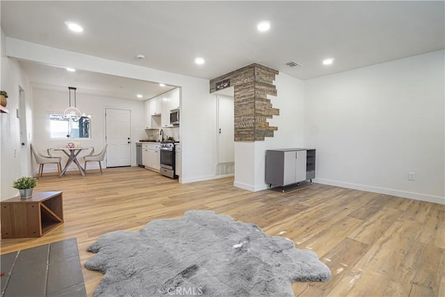 8283 Cornwall Ave, Rancho Cucamonga, CA 91739 - living area featuring light wood-type flooring, recessed lighting, and a chandelier