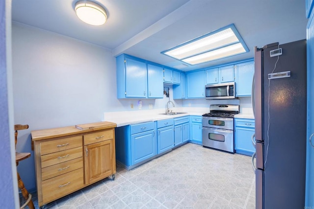 3833 Via Del Bardo, San Ysidro, CA 92173 - kitchen featuring stainless steel appliances, light countertops, and blue cabinetry