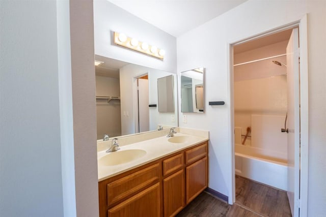 3833 Via Del Bardo, San Ysidro, CA 92173 - bathroom featuring wood finished floors, double vanity, and  shower combination