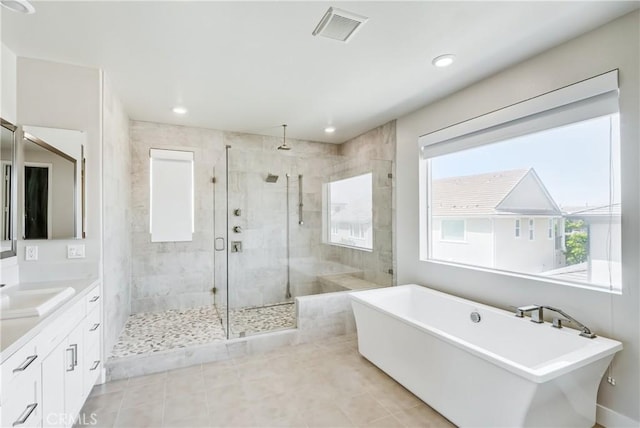54 Sagan Way, Irvine, CA 92618 - bathroom featuring a shower stall, a freestanding bath, vanity, tile patterned flooring, and recessed lighting