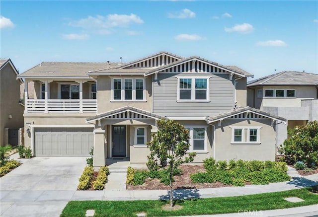 54 Sagan Way, Irvine, CA 92618 - view of front of home featuring stucco siding, an attached garage, driveway, and a balcony