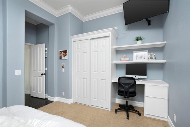 25 Thalia St, Ladera Ranch, CA 92694 - bedroom featuring built in desk, a closet, carpet flooring, and crown molding