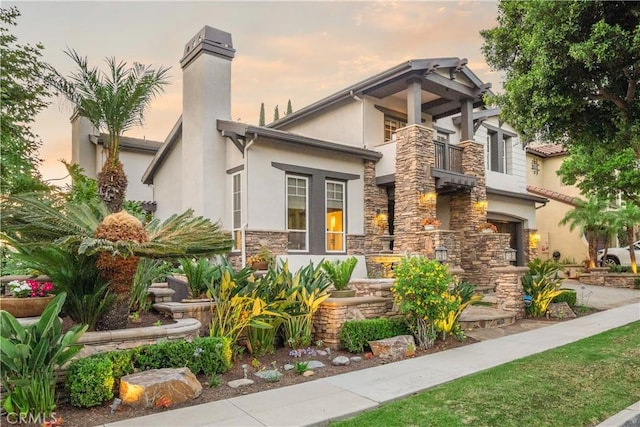 25 Thalia St, Ladera Ranch, CA 92694 - craftsman house with stone siding, a balcony, stucco siding, and a chimney
