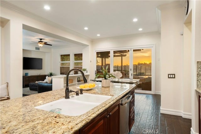 25 Thalia St, Ladera Ranch, CA 92694 - kitchen with dishwasher, dark wood finished floors, ornamental molding, light stone countertops, and ceiling fan