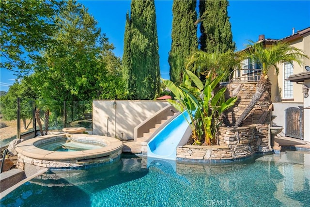 25 Thalia St, Ladera Ranch, CA 92694 - view of swimming pool featuring a water slide, a pool with connected hot tub, and stairs