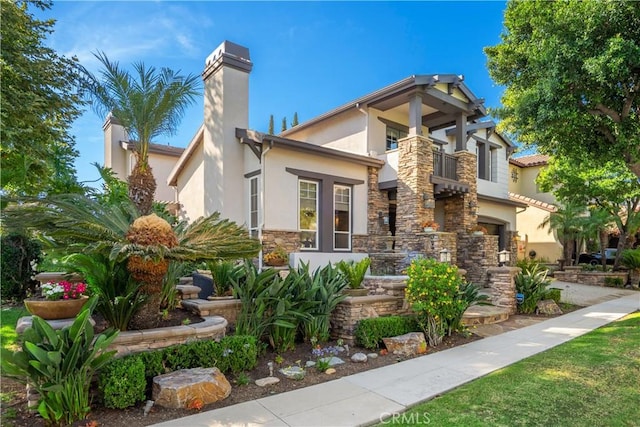 25 Thalia St, Ladera Ranch, CA 92694 - view of front of home with stucco siding, a balcony, a chimney, and stone siding
