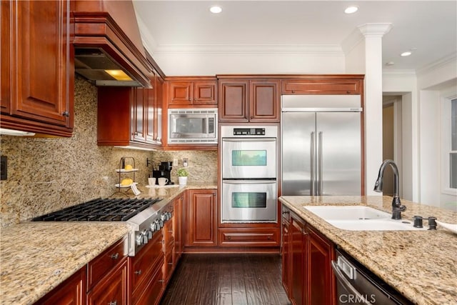 25 Thalia St, Ladera Ranch, CA 92694 - kitchen with built in appliances, premium range hood, light stone countertops, dark wood finished floors, and crown molding