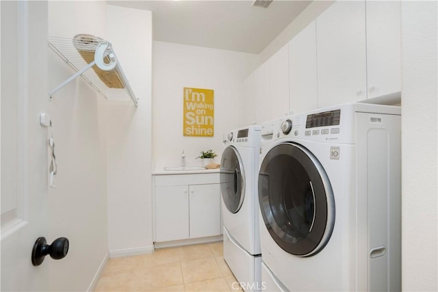 25 Thalia St, Ladera Ranch, CA 92694 - washroom featuring washing machine and dryer, light tile patterned floors, and cabinet space